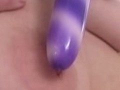 Busty Holly sucking her own tits and masturbates her pussy