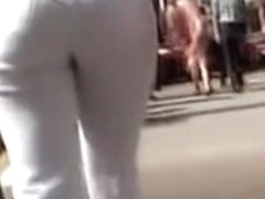 Girl in white trousers is on the street candid video 06m