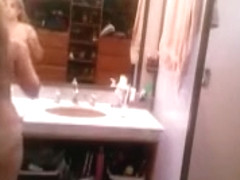 Busty blonde brushes her hair and takes a shower