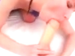 Redhead plays with her ass in the bathroom