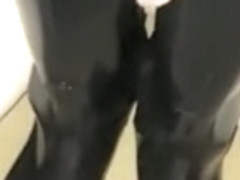 Penis between rubber riding boots