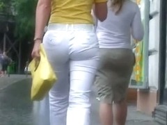 Classy blonde in heels and white pants in a street candid vid