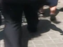 A hefty xxxl woman in a street candid video walks in tight black jeans