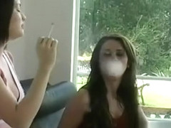 This slut shows her huge bust while holding a cigarette