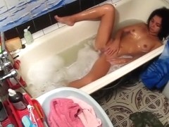 Tanned solo chick in the bathtub