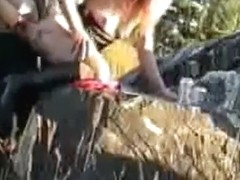 Mature woman gets doggystyle fucked on a rock in nature