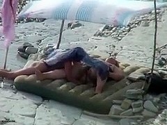 Amateur couple is having sex on the beach