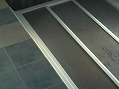 Voyeur tapes a brunette naked in the bathroom