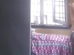 Big Tit Indian Aunty Rubs on Lotion in Open Window