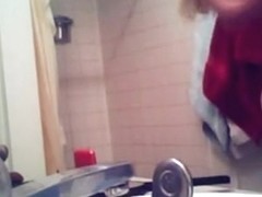 Voyeur captures a hot brunette naked in the bathroom