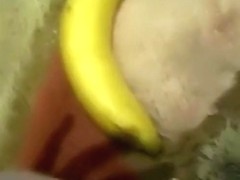 girl wildly masturbates with a banana on the floor and moans
