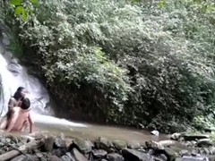 Latin couple makes a sextape near a waterfall in nature