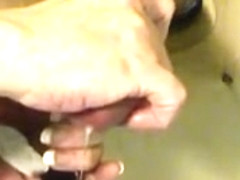 She ties up his dick through a cock board and squeezes it h