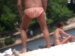 Nudists are enjoying themselves on the beach on cam