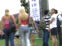 Sweet ass blonde girls get followed by a voyeur cameraman on a festival