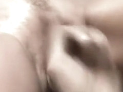 Horny redhead milf in white lingerie gives a nice blowjob on the couch