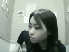 Nice asian woman is caught on camera while pissing in toilet