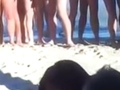 Amateur swingers on the nudist beach having groupsex