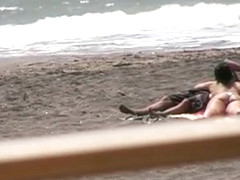 Nude hot ass brunette gives blowjob and hand job on the beach