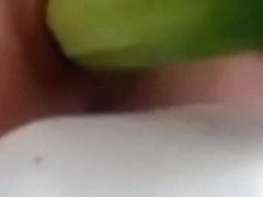 Hawt chick masturbates in her bedroom using a cucumber