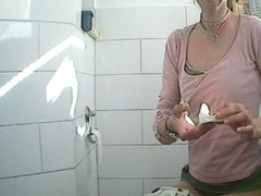 Spying on this female in bathroom while pissing