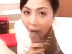 Elegant Japanese lady with a pretty smile worships a fat co